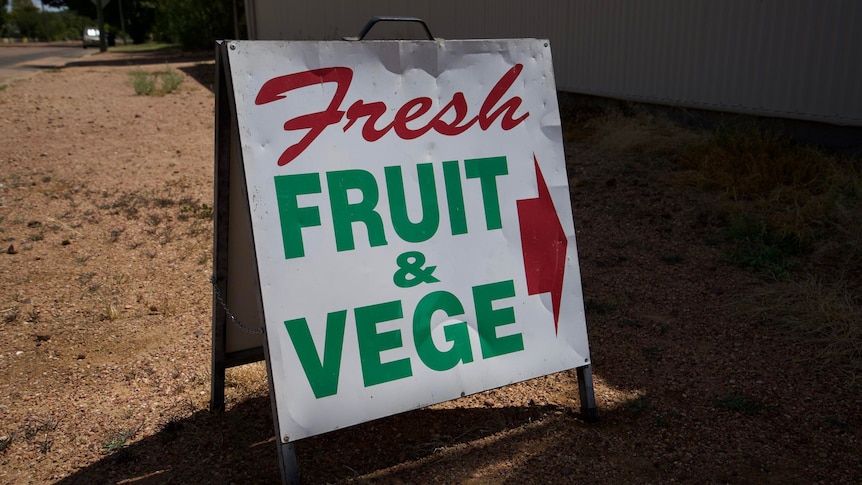 Sign that says fruit and veg in red letters