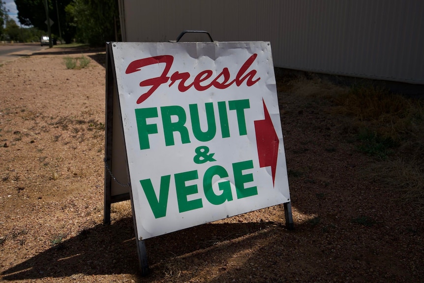 Sign that says fruit and veg in red letters