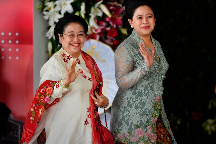 Two Indonesian women waving 