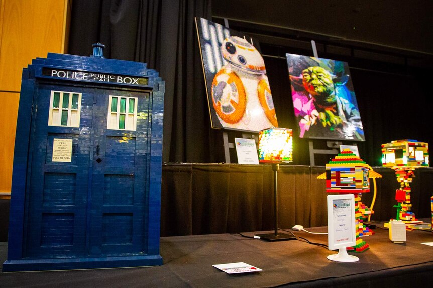 A LEGO Tardis is on display next to LEGO canvases showing BB-8 and Yoda