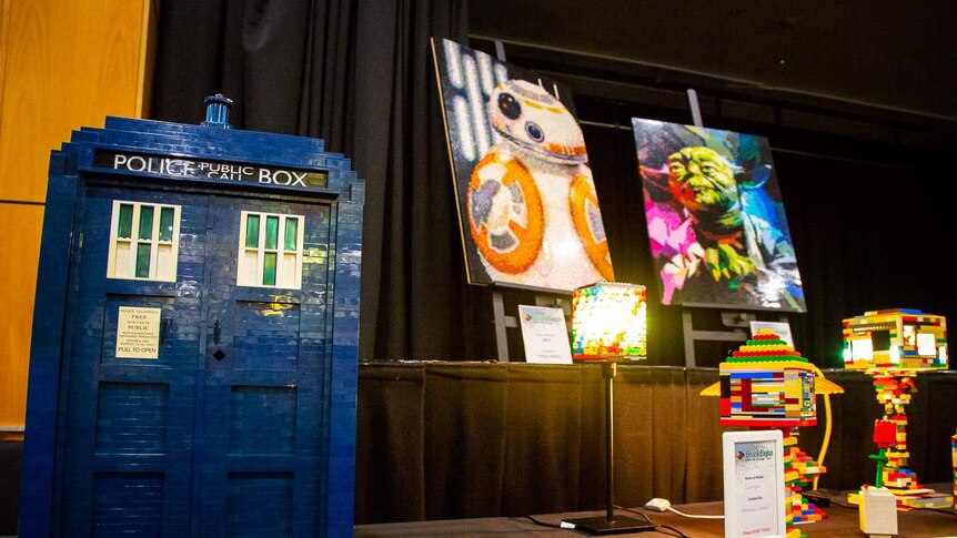 A LEGO Tardis is on display next to LEGO canvases showing BB-8 and Yoda