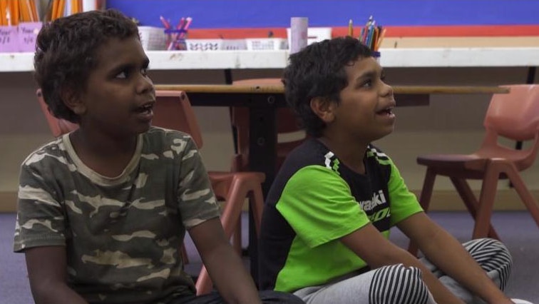 Two Indigenous boys sit in classroom