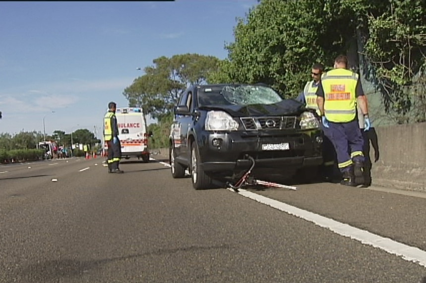 A bike lies wedged under the car after the Sydney crash which injured seven cyclists.