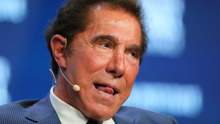 Steve Wynn waits to answer a question on stage at a conference.
