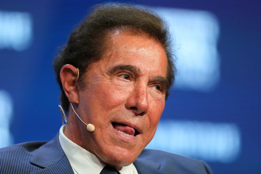 Steve Wynn waits to answer a question on stage at a conference.
