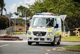 Queensland ambulance driving on a street, responding to a call