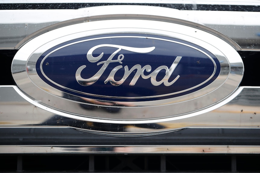 A Ford logo is displayed at a Ford dealership in the United States.