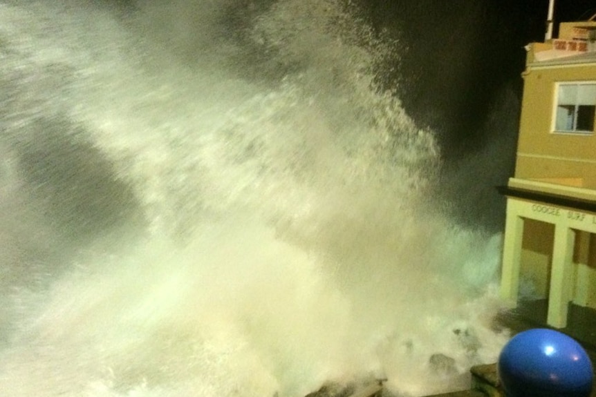 Spray from a huge wave hitting the surf club.