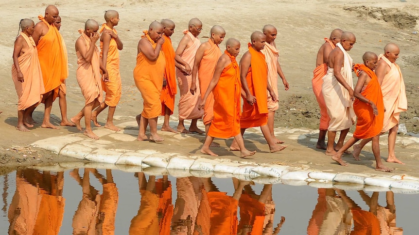 Newly initiated Hindu holy women walk along the Ganges