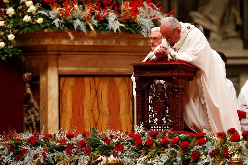 Pope Francis kneels to pray