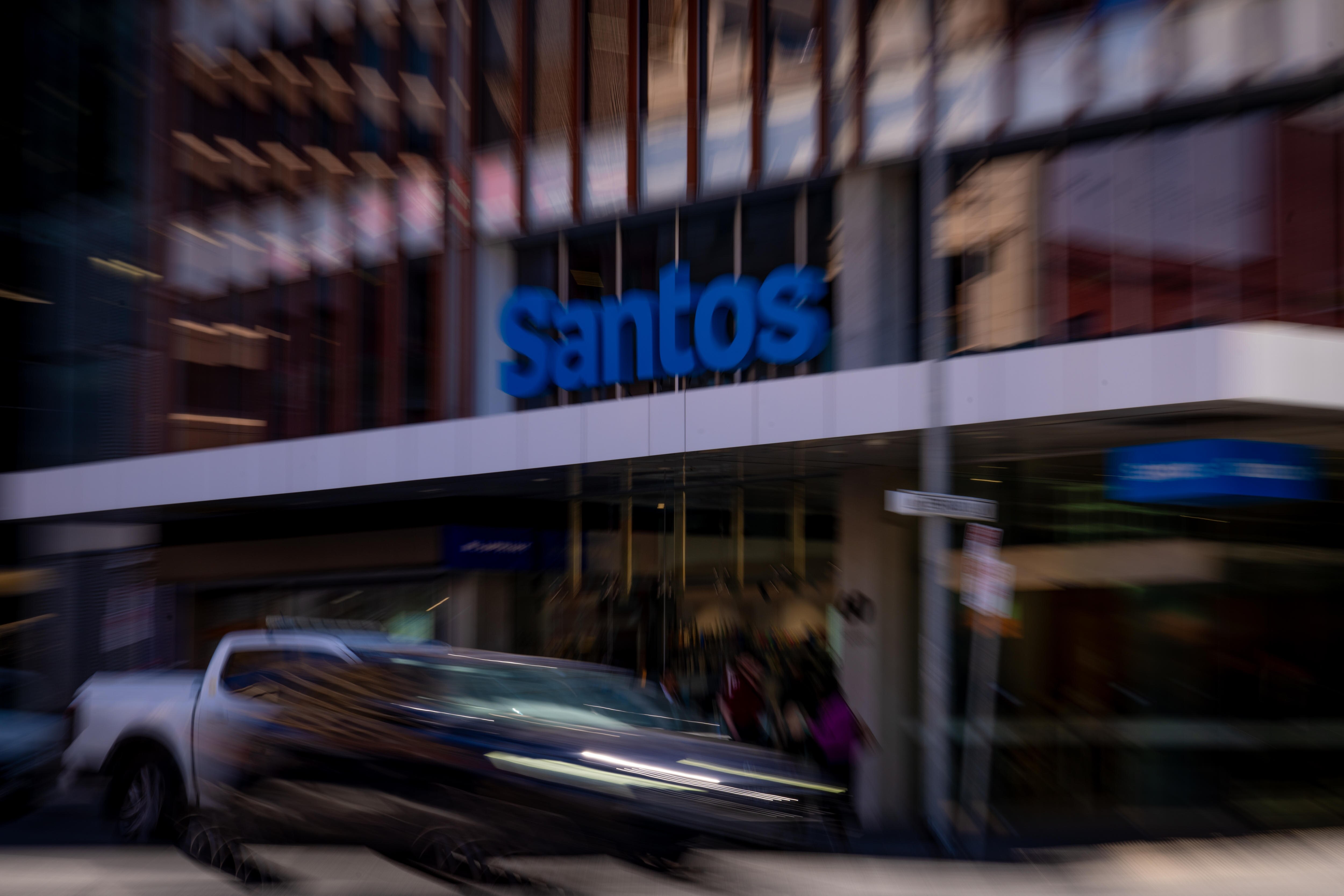 A blurry image of Santos signage on an office building