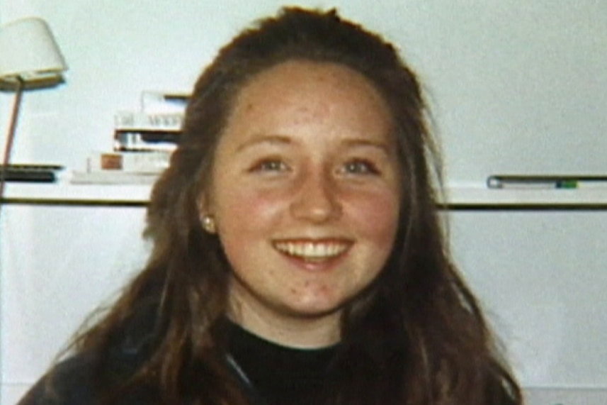 A head and shoulders shot of a smiling Sarah Spiers with long hair and a dark top.