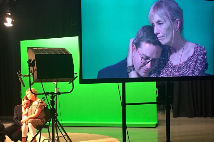 Rosie Connellan and Thomas Zinn embrace on set.