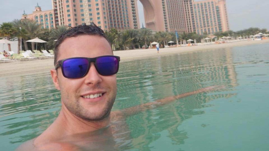 Photo of British man Jamie Harron who was detained in Dubai. Undated. He is swimming and wearing sunglasses.