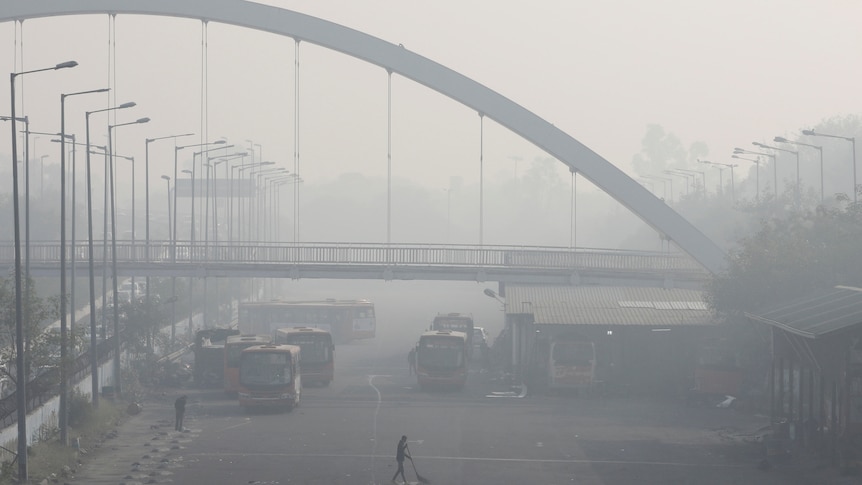 Thick smog is seen at a bus depot in New Delhi