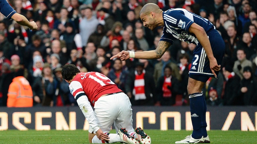 Steven Reid (R) shouts at Arsenal's Santi Cazorla after the Spaniard won a penalty in the Gunners' 2-0 win.