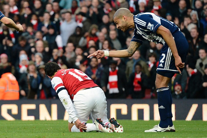 Steven Reid (R) shouts at Arsenal's Santi Cazorla after the Spaniard won a penalty in the Gunners' 2-0 win.