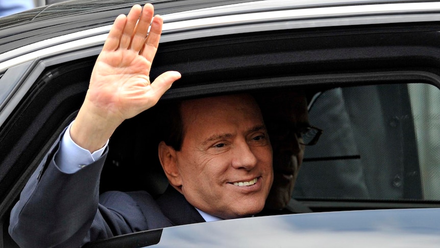 Mr Berlusconi waves as he leaves the Justice Palace in Milan on September 19, 2011.