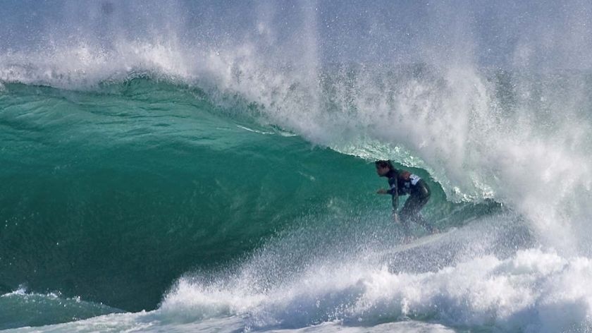 Tasmanian surfer Dustin Hollick rides on his way to defeating Jarred Sullivan.