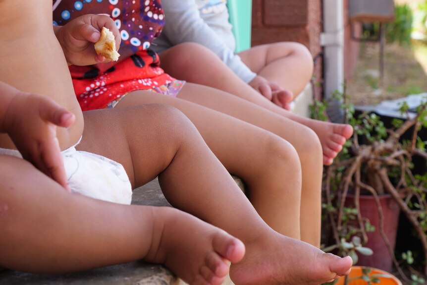 Close up of legs of babies and young children.