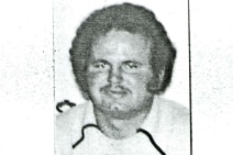 A white man in a scanned black and white headshot photo 