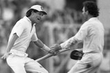 Black and white photo that shows Dean Jones wearing a white hat, stump in hand going to embrace Allan Border.