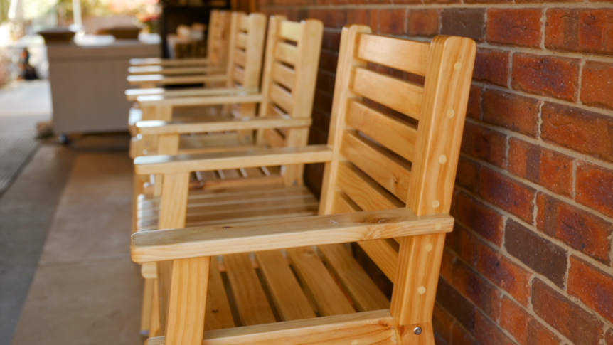 A row of ornate wooden chairs.