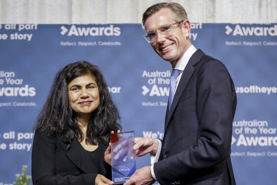 a man presenting a woman with an award