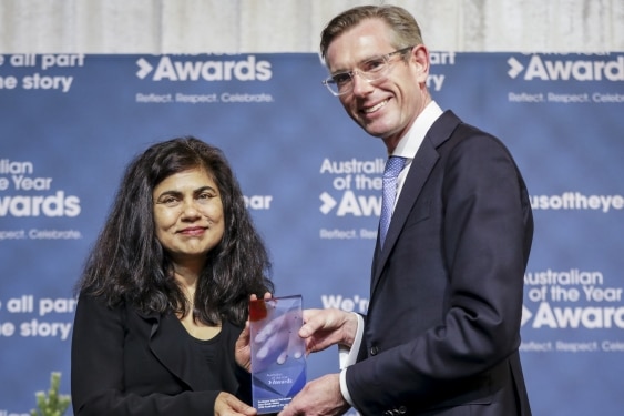 a man presenting a woman with an award