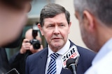 Kevin Andrews speaks to reporters