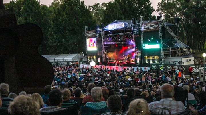 Main stage in Tamworth's Bicentennial park lit up and surrounded by a sea of country fans
