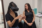 All in the Mind presenter Sana Qadar has a VR headset on and is watched by psychologist Corrie Ackland