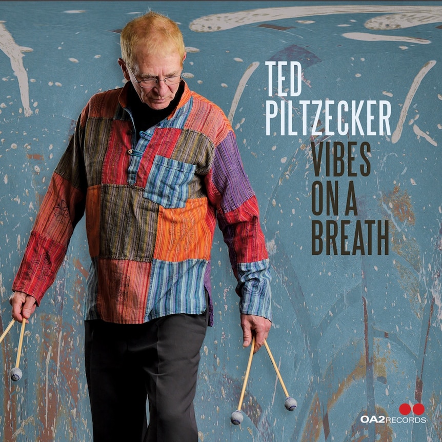 Ted Piltzecker's 'Vibes On A Breath' cover featuring Ted with his mallets in a red and blue jumper