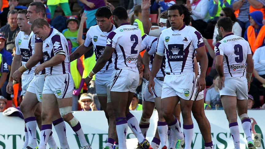 Storm team-mates celebrate try against Knights