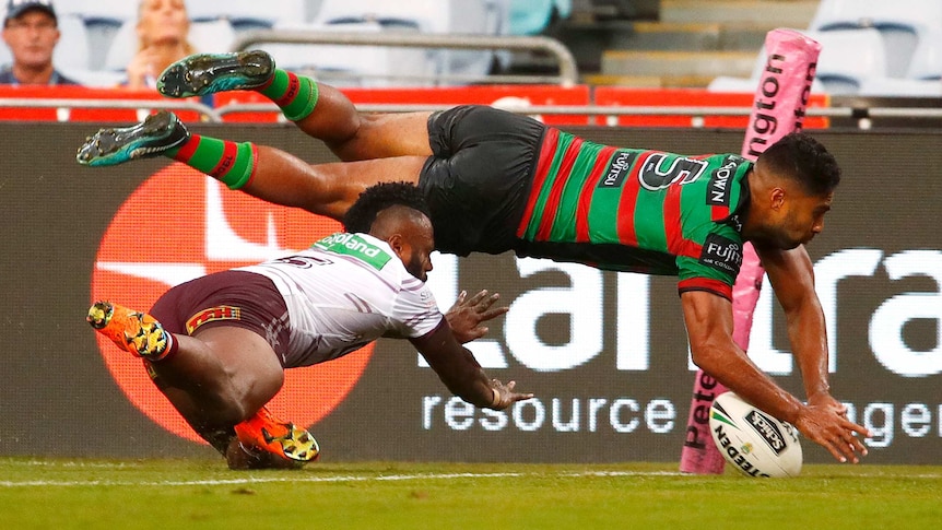 Robert Jennings of the Rabbitohs scores a try against Manly at the Olympic stadium.