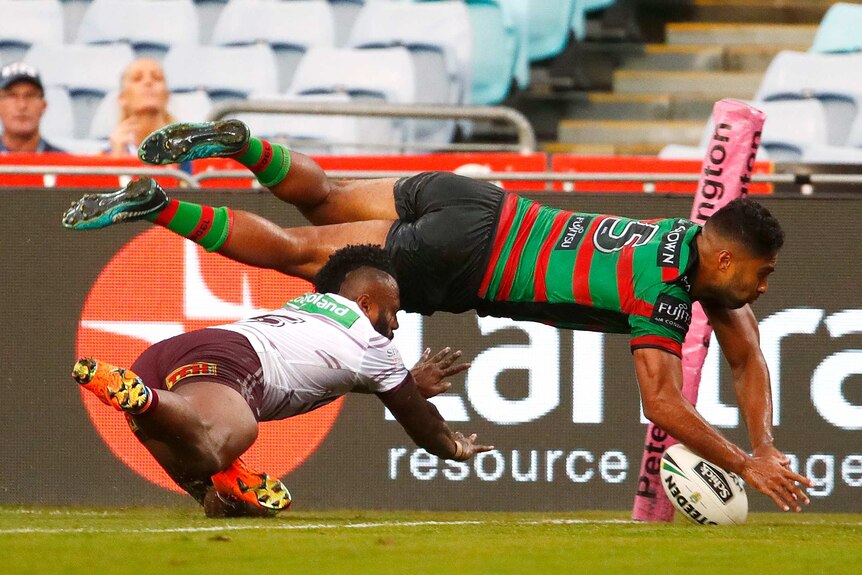 Robert Jennings of the Rabbitohs scores a try against Manly at the Olympic stadium.