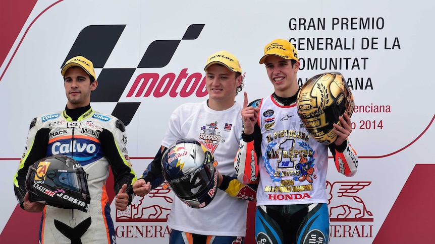 Jack Miller celebrates winning the Valencia MotoGP, while Alex Marquez celebrates winning the Moto3 championship
