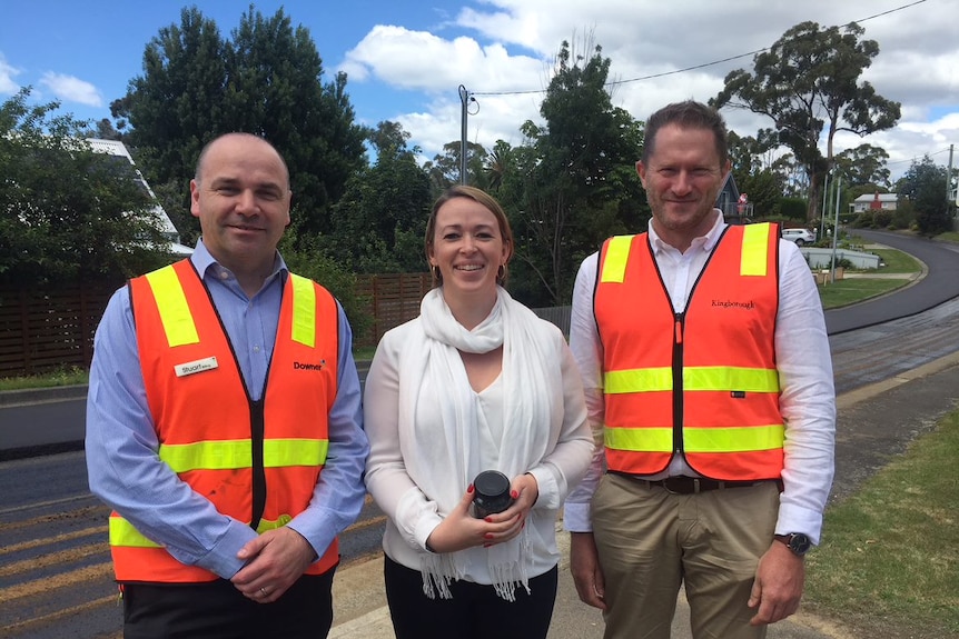 Stuart Billing (left), Nerida Mortlock (centre) and Richard Atkinson (right) stand in front of the newly surfaced road.