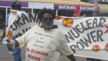 Marching in front of an anti-uranium sign is Pastor Geoffrey Stokes in Kalgoorlie in 2011
