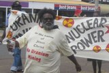 Marching in front of an anti-uranium sign is Pastor Geoffrey Stokes in Kalgoorlie in 2011.