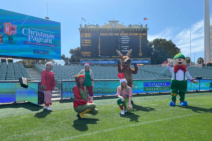 People in Christmas outfits on Adelaide Oval.