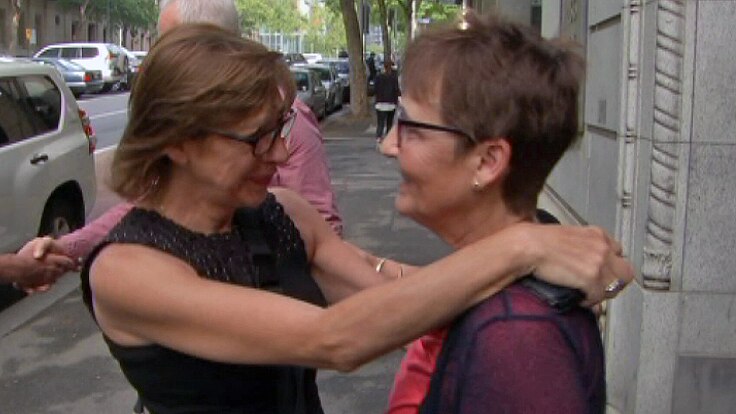 Giulia Mandarino (left) hugs Debbie Barker outside the court.