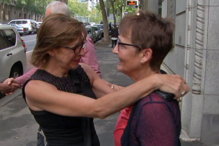 Giulia Mandarino (left) hugs Debbie Barker outside the court.