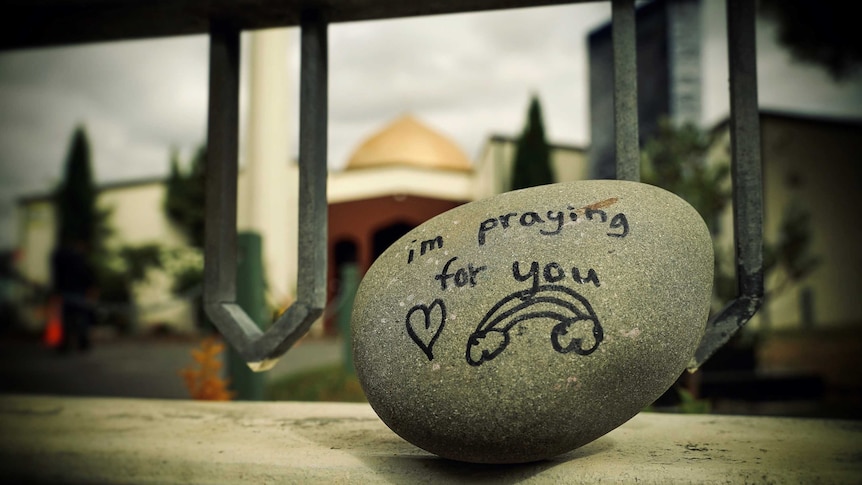 A rock outside the Al Noor Mosque reading 'i'm praying for you'