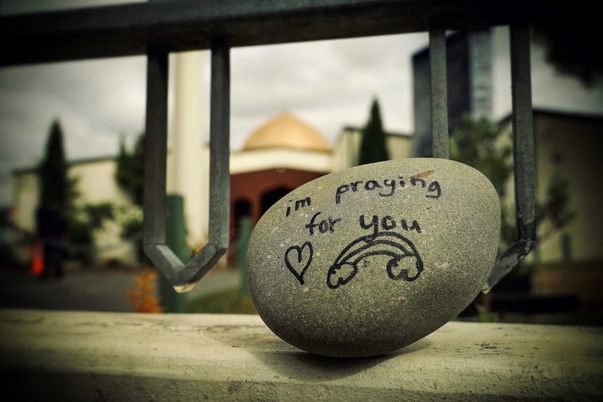 A rock outside the Al Noor Mosque reading 'i'm praying for you'