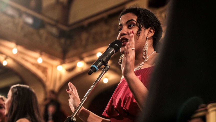 Woman singing in front of a microphone