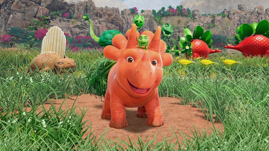 Image from Ginger and the Vegesaurs featuring an orange animated Vegesaur smiling at the camera.