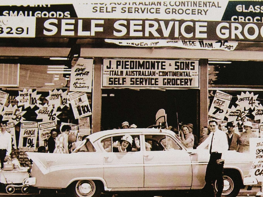 Evie Hayes waves from the car window at the front of the store