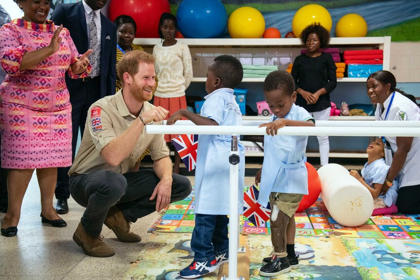 Prince Harry meets with young children at a orthopaedic centre in Angola