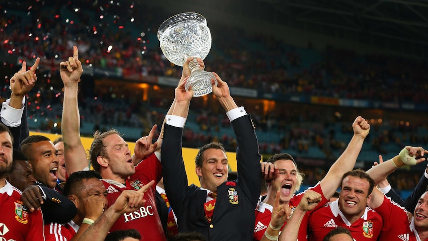 To the victors the spoils ... Injured Lions captain Sam Warburton hold the Tom Richards Cup aloft